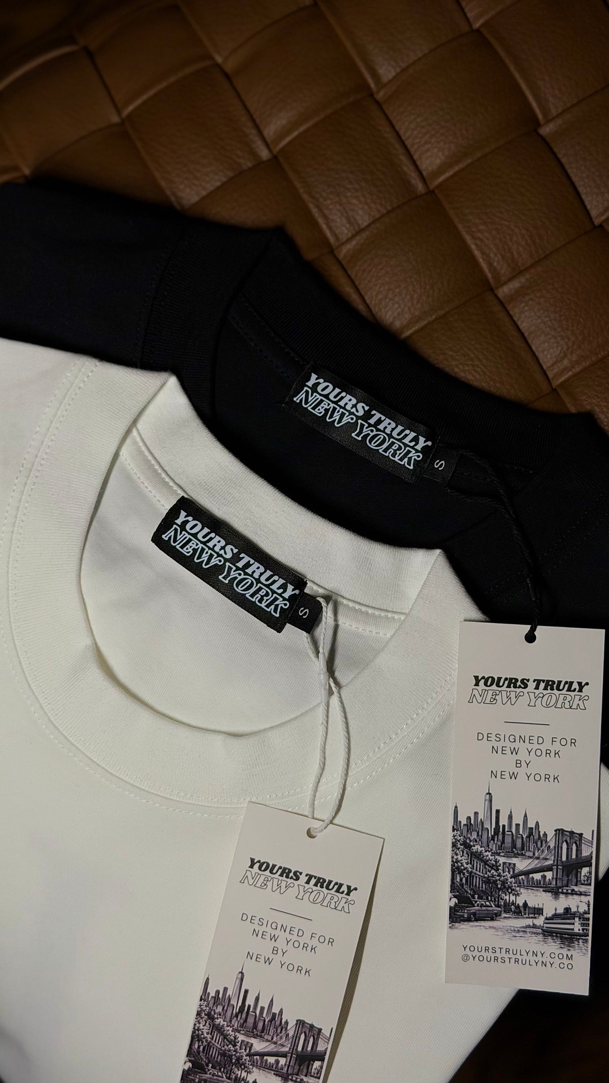 Yours Truly New York neck labels and Designed for New York by New York hang tags on white and black tees